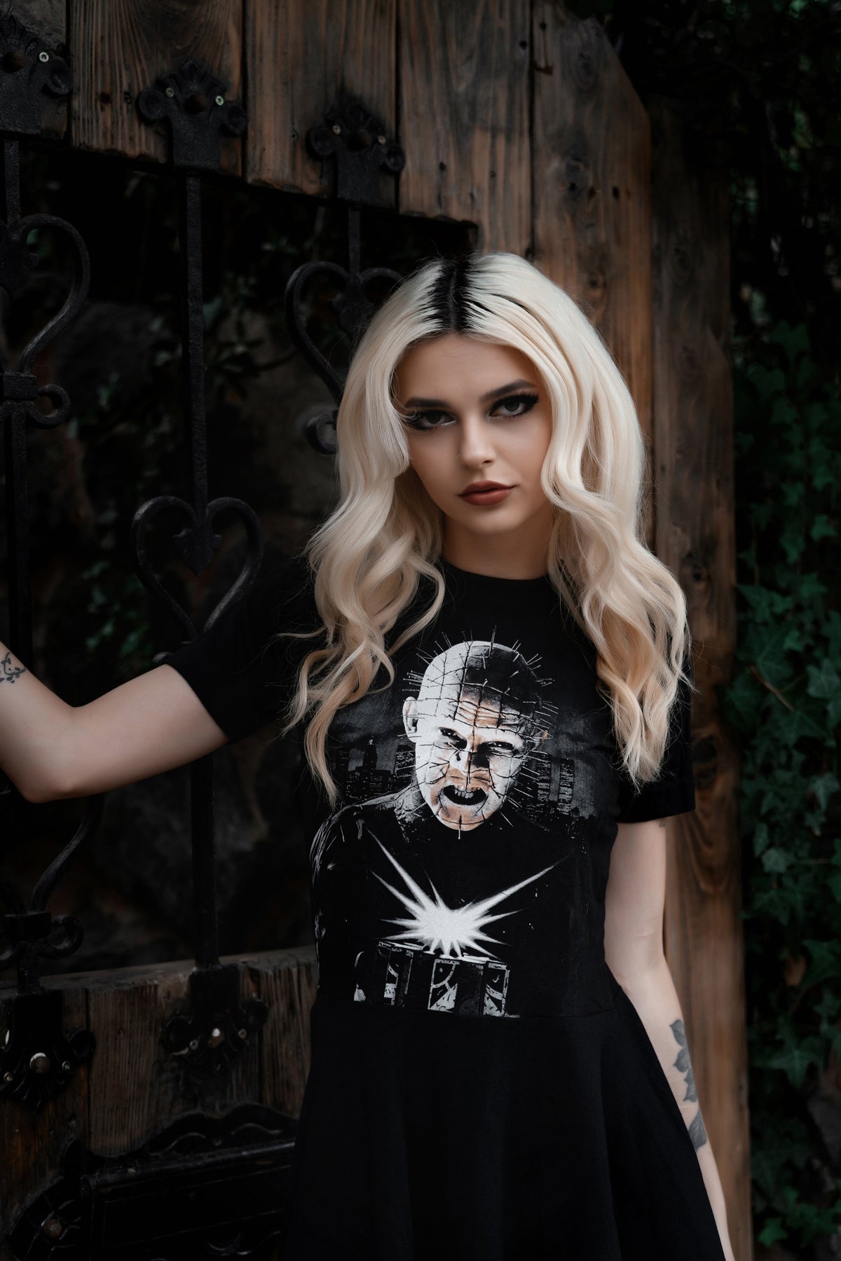 Person wearing a black t-shirt with graphic design in front of a dark background