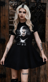 Woman wearing a black t-shirt with graphic design against a wooden background