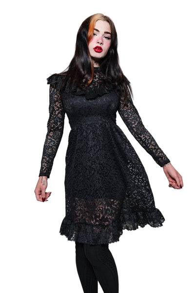 Woman wearing a black lace dress on a white background