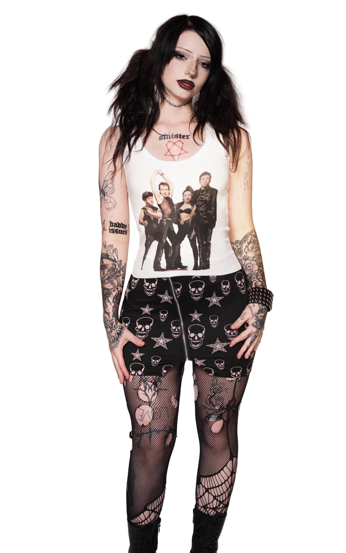 Person wearing a sleeveless top with graphic design and black lace pants on a white background