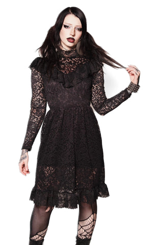 Woman wearing a black lace dress on a white background