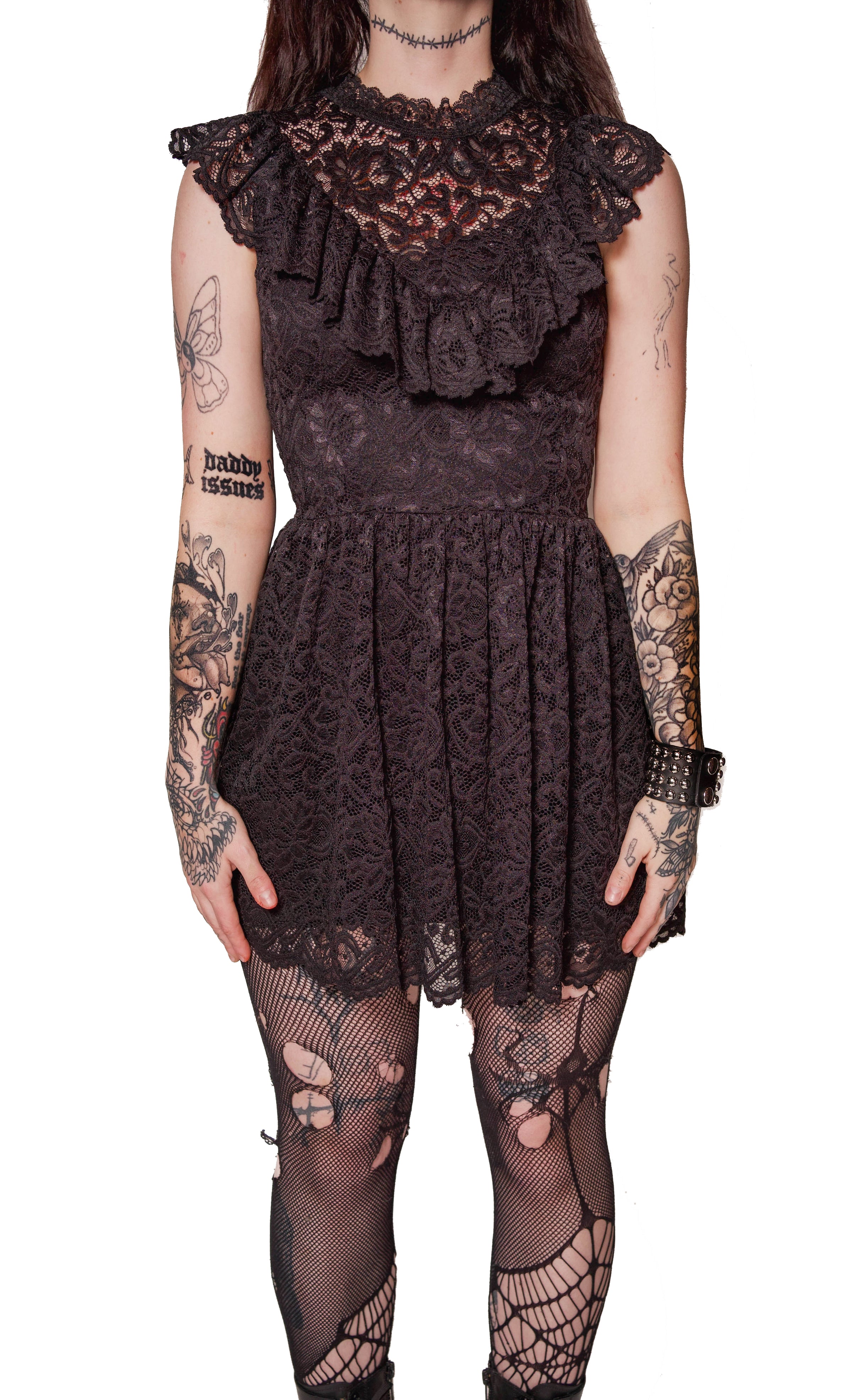 Person wearing a black lace dress with ruffled top on a white background