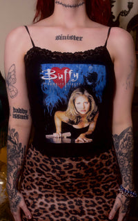 Person wearing a tank top with 'Buffy the Vampire Slayer' design and leopard print skirt.