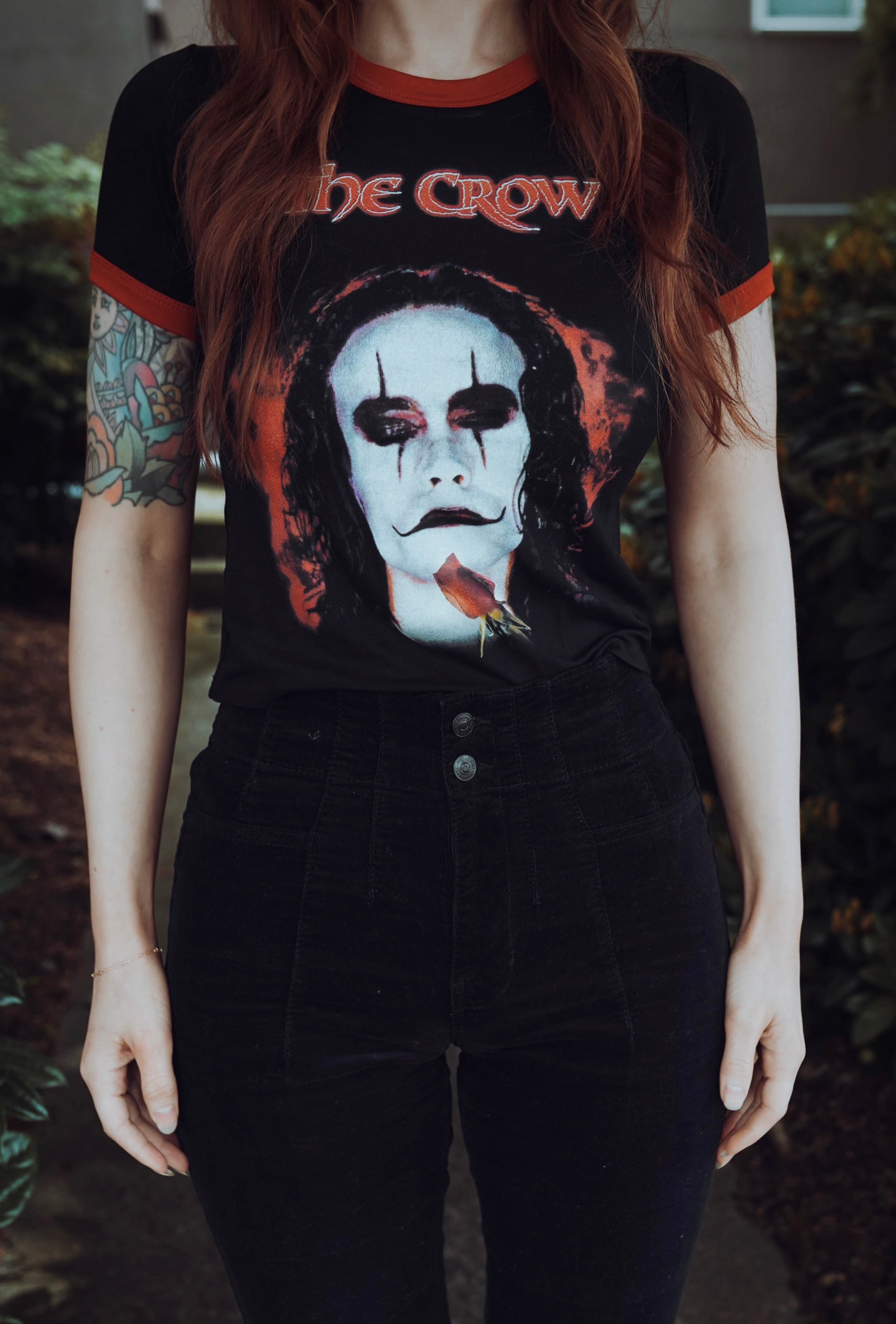 Person wearing a 'The Crow' t-shirt with a dark background