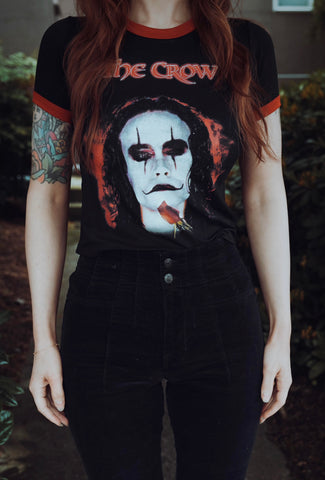 Person wearing a 'The Crow' t-shirt with a dark background