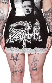 Person wearing a black hoodie with 'Death' logo and lace trim, tattoos visible on arms and legs.