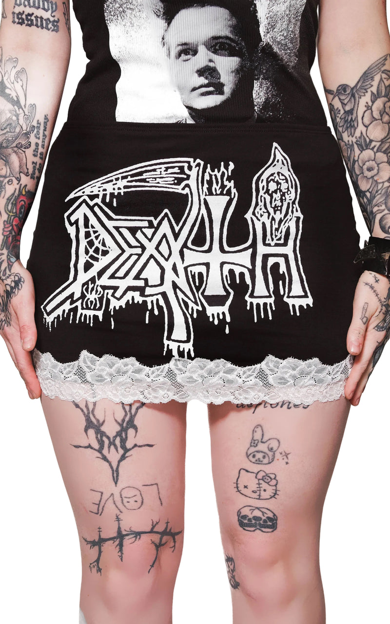 Person wearing a black hoodie with 'Death' logo and lace trim, tattoos visible on arms and legs.