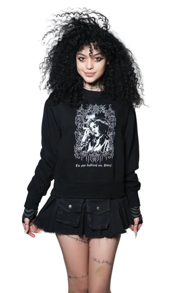 Person wearing a black sweatshirt with a graphic design on a white background