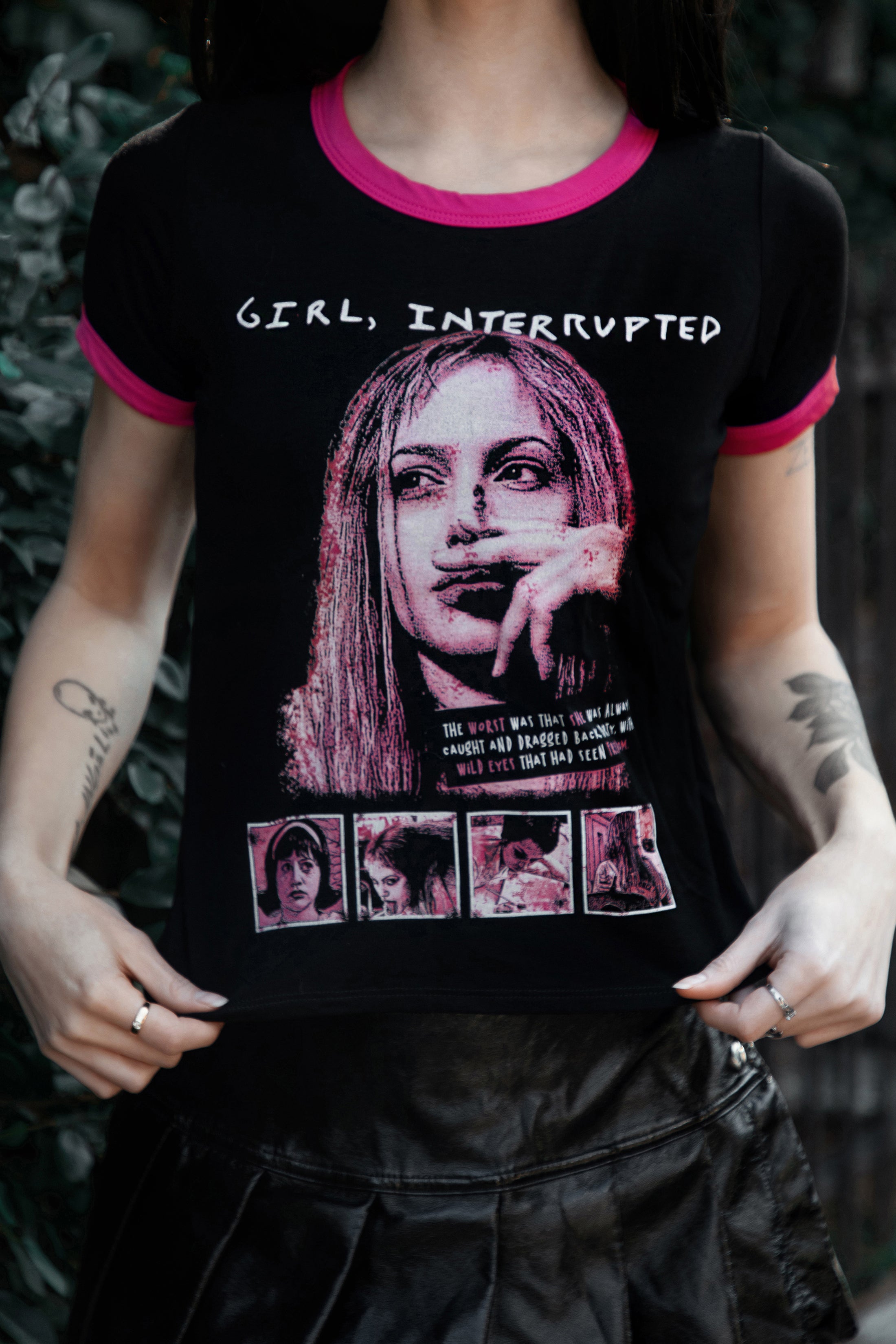 Person wearing a black t-shirt with graphic design and text