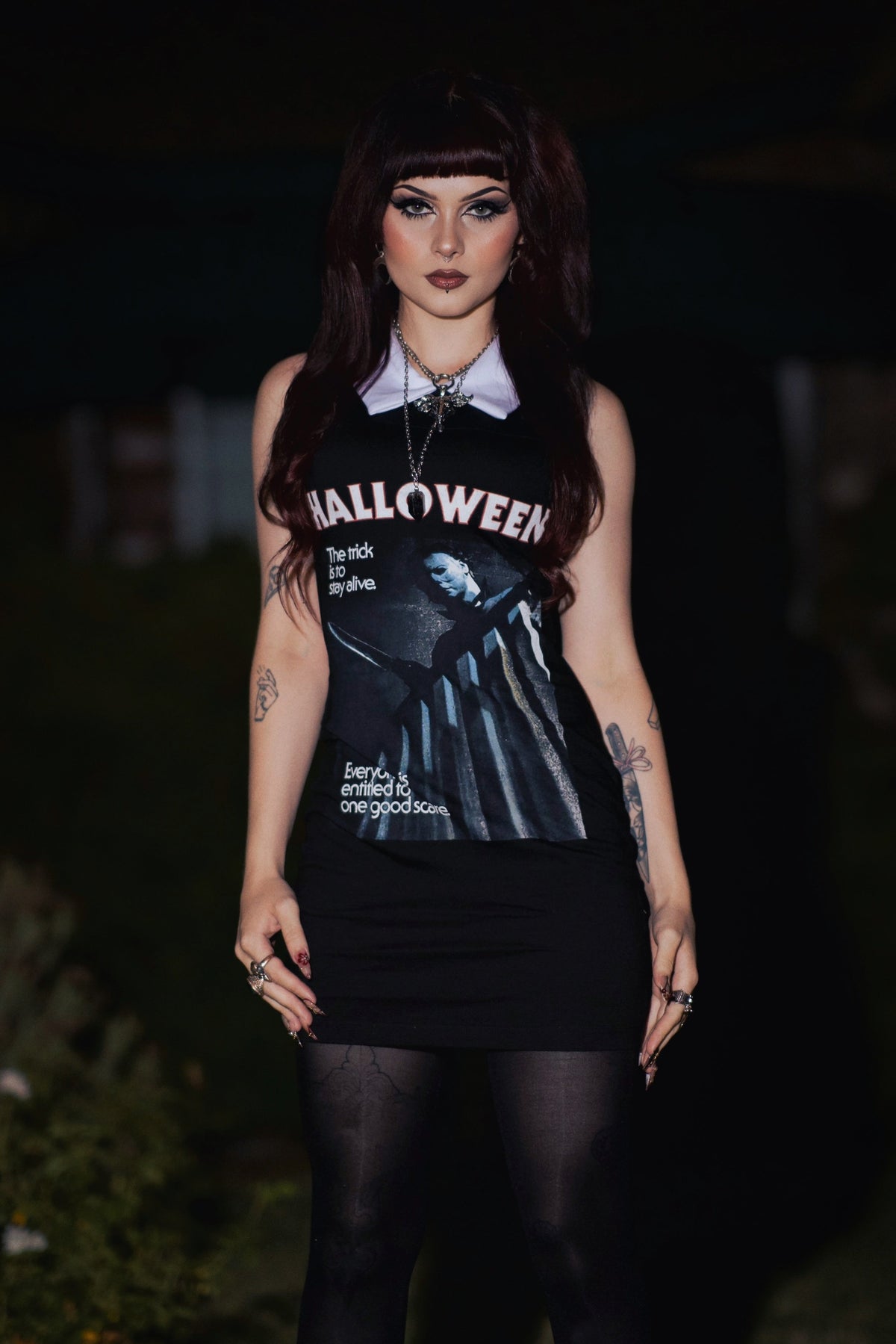 Person wearing a 'Halloween' themed sleeveless top with a dark background