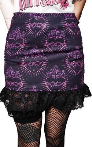 Black skirt with purple heart and cross pattern worn by a person.