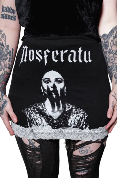 Black skirt with 'Nosferatu' design worn by a person with tattoos on a white background