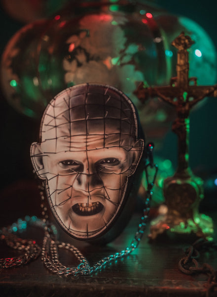 Horror-themed mask with chains and dark background