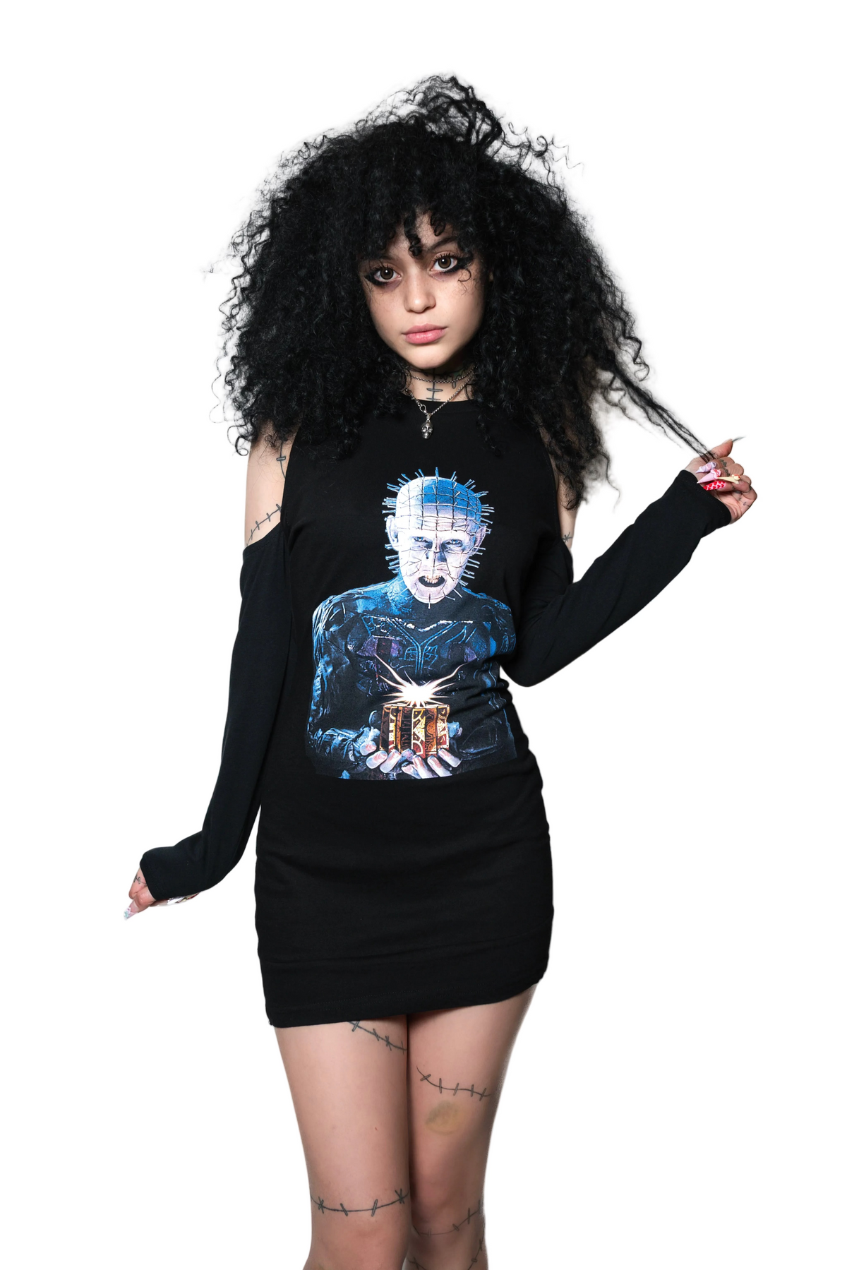 Person wearing a black long-sleeve top with a graphic design on a white background