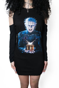 Person wearing a black long-sleeve shirt with a graphic design of a character holding a light bulb.