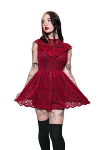 Woman wearing a red lace dress on a white background