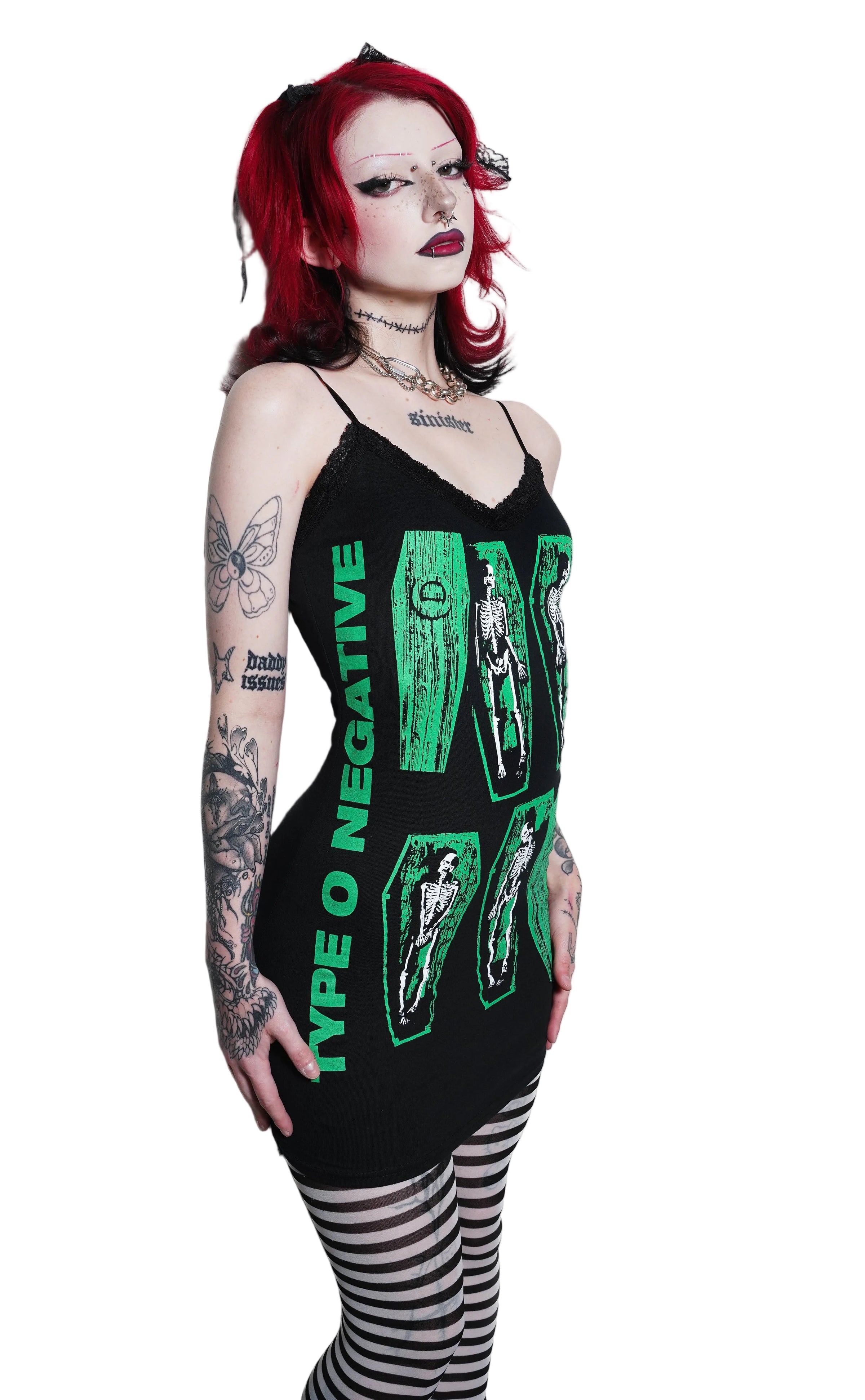 Person wearing a black tank top with green text and graphics on a white background