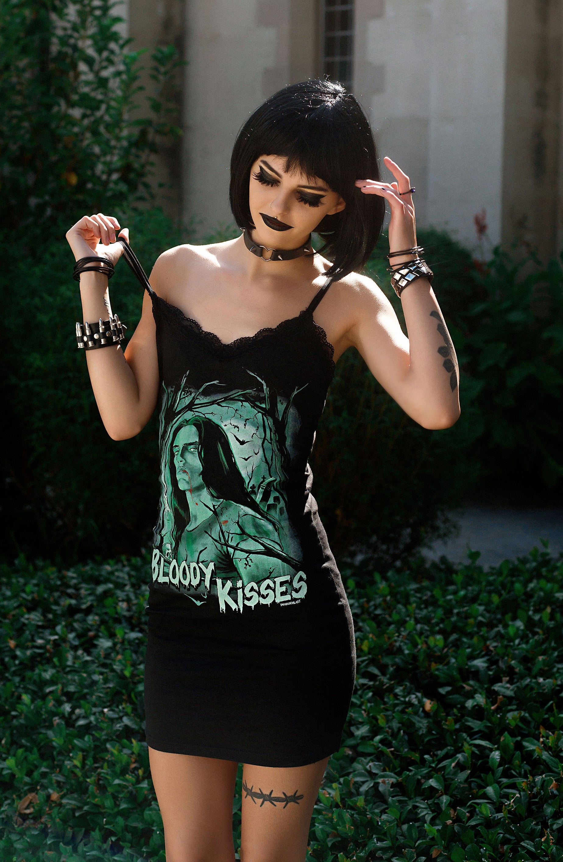 Black thin strap mini dress with black lace trim neckline. Features green print image of Peter Steele with trees in background. Green inscription reads "BLOODY KISSES"