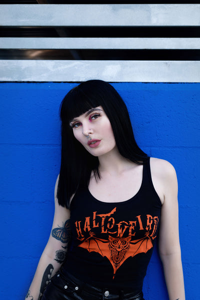 Black cropped tank with orange font that reads "Halloweird" with orange bats