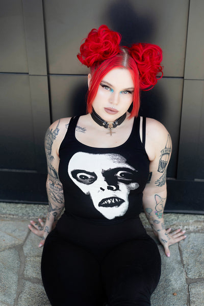 Black tank top. Features white print face of Pazuzu.