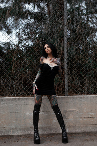 Black mini dress with puff off shoulder sleeves and embellished white Victorian style neckline.