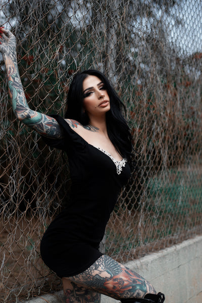 Black mini dress with puff off shoulder sleeves and embellished white Victorian style neckline.