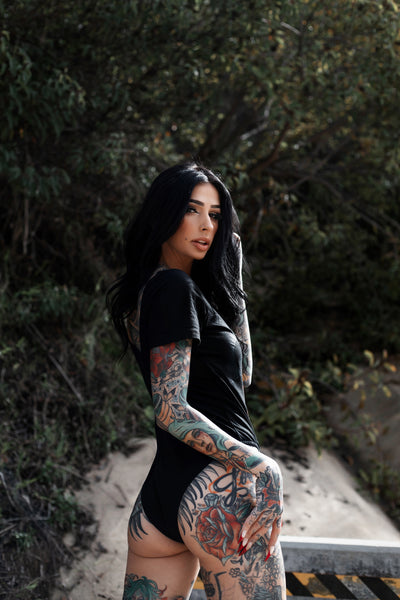 Back of black cheeky short sleeve bodysuit.