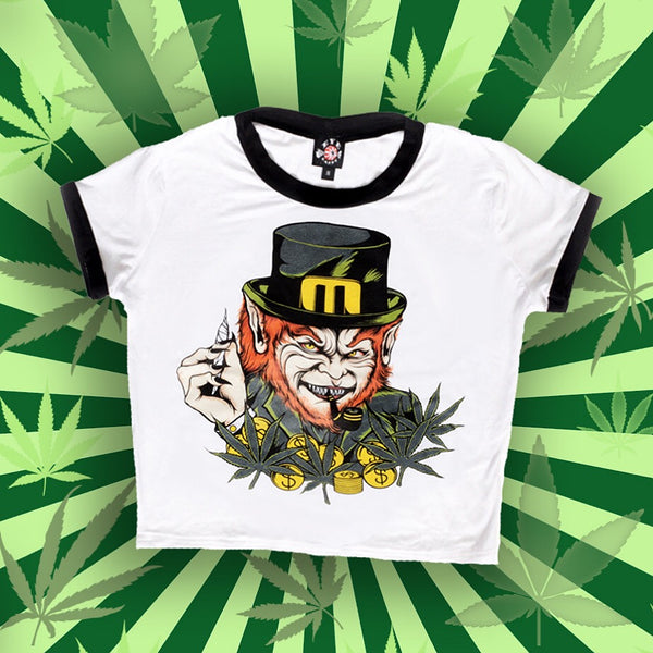 White ringer tee with black trim. Features image of evil Leprechaun with red hair and sharp teeth wearing green while holding a joint with black and yellow pipe in mouth. Yellow coins and green marijuana leaves in foreground.