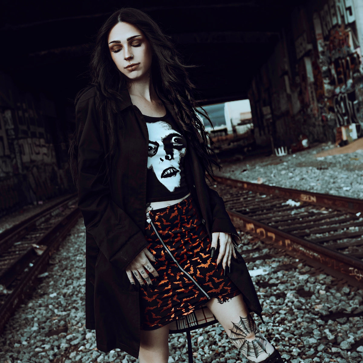 Black tank top. Features white print face of Pazuzu.