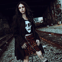 Black tank top. Features white print face of Pazuzu.