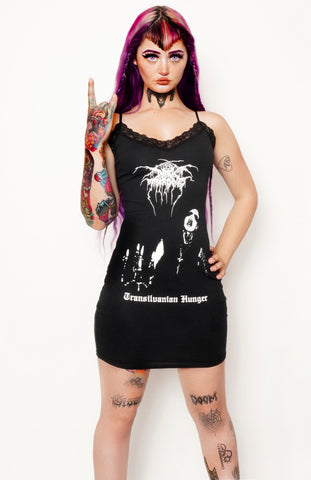 Black dress with thin straps and black lace trim neckline. Print shows white font reading "Dark Throne" and "Transilvanian Hunger". Features man with corpse paint makeup and candelabrum.