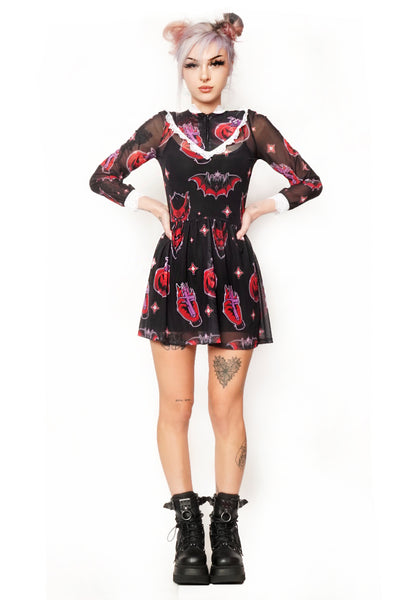 Sheer black Victorian style dress with white lace trim neckline and wrist cuffs. V shape lace trim from chest to shoulders. Black zipper from neckline to V shape white lace trim. Features devil, bat, pumpkin, hand with cross pattern.