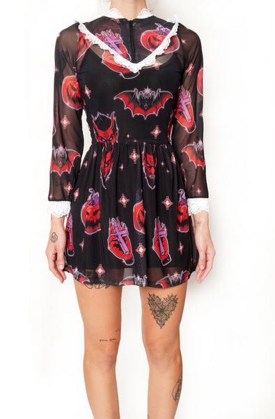 Sheer black Victorian style dress with white lace trim neckline and wrist cuffs. V shape lace trim from chest to shoulders. Black zipper from neckline to V shape white lace trim. Features devil, bat, pumpkin, hand with cross pattern.