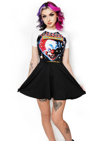 Black baby doll dress with white short sleeves and white trim neckline. Features image of evil clown face with popcorn around him. Inscription reads "Killer Klowns" in red "From Outer Space" in blue and "In Space No One Can Eat Ice Cream!" in yellow.