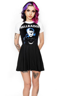 Black baby doll style dress with white baseball short sleeves and white trim neckline. Features Pinhead from the movie Hellraiser. Inscription in white reads "Hellraiser".