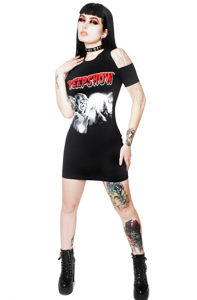 Black short sleeves mini dress with cut out shoulder detail. White print features cloaked monster with full moon in background. Inscription  reads "Creepshow" in red.