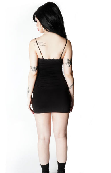 Back of black mini dress with thin straps and lace trim neckline