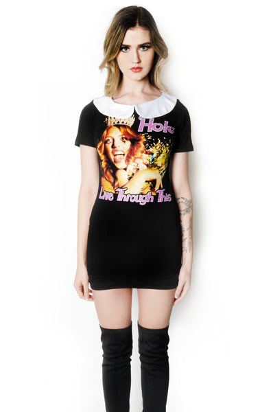 Black short sleeve mini dress with white peter pan style collar. Features image of woman wearing crown and holding flowers. Inscription in pink reads "HOLE" and "Live Through This"
