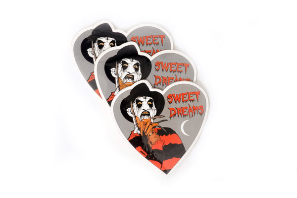 Heart shape Vinyl sticker. Features Freddy Krueger with corpse paint and crescent moon. Inscription reads "Sweet Dreams" in red.