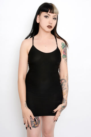Black slip mini dress with thin black straps.