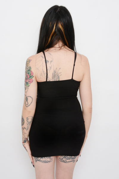 Black slip mini dress with thin black straps.