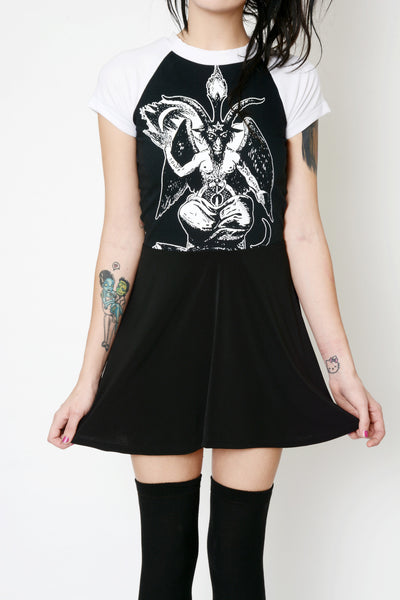 Black baby doll style dress with white baseball tee short sleeves and white trim neckline. White print on dress features Baphomet goat.