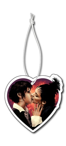 Heart shape air freshener with white elastic band. Features Nancy from the movie "The Craft" and Lydia from "Beetlejuice" kissing.
