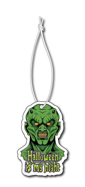 Air freshener with white elastic band. Features green monster with yellow eyes and reads "Halloween is my night" in light green font