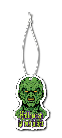Air freshener with white elastic band. Features green monster with yellow eyes and reads "Halloween is my night" in light green font