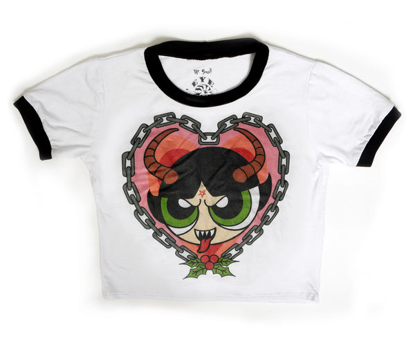 White ringer tee with black trim. Features image of Buttercup from the Powerpuff Girls with pentagram on forehead and horns, sticking her tongue out with sharp teeth. Heart shape chain border around image with mistletoe below.