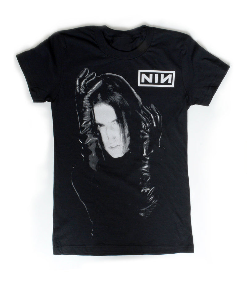 black short sleeve T-shirt. White print features man with black gloves holding his face. Inscription reads "NIN" in white.