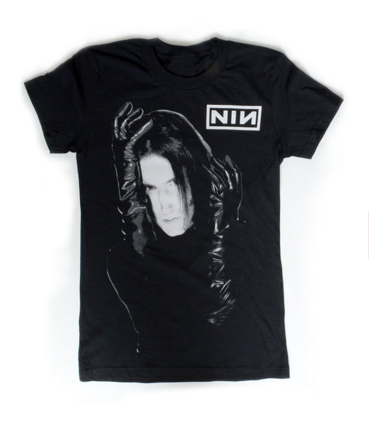 black short sleeve T-shirt. White print features man with black gloves holding his face. Inscription reads "NIN" in white.