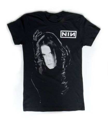 black short sleeve T-shirt. White print features man with black gloves holding his face. Inscription reads "NIN" in white.