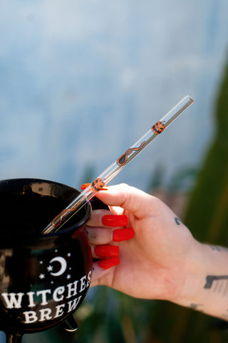 Glass clear straw. Features orange and black image of jack o lantern and noose.